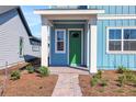 Inviting front porch with white columns and a green door, leading to a welcoming home at 3034 Voyager Ave, St Cloud, FL 34771