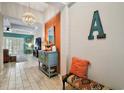 Open entryway with decorative chandelier and views into the adjacent living area at 31857 Dahlia Ct, Eustis, FL 32736