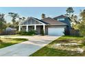 Beautiful two-story home featuring a 2-car garage, concrete driveway, and lush green lawn at 31857 Dahlia Ct, Eustis, FL 32736