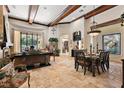 Open concept living room featuring coffered ceilings, tile floors, and large picture window at 32543 Hawks Lake Ln, Sorrento, FL 32776