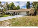 Beautiful single-story home featuring a two-car garage and well-maintained landscaping at 3430 Laurel Dr, Mount Dora, FL 32757