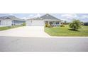 Inviting home with a well-maintained lawn and a spacious driveway at 3532 Thorne Path, Oxford, FL 34484