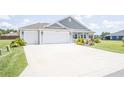 Well-kept home featuring a spacious driveway and an attached two-car garage at 3532 Thorne Path, Oxford, FL 34484