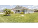 Home with a lush lawn and mature landscaping adding to its curb appeal at 3532 Thorne Path, Oxford, FL 34484