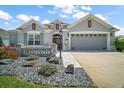 Well-maintained home with a two-car garage, beautiful landscaping, and a stone walkway at 3537 Cluster Ct, The Villages, FL 32163