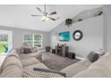Cozy living room with a large sectional sofa, entertainment center, and ample natural light at 36700 Oconee Ave, Eustis, FL 32736