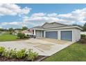 Single-story home boasts a three-car garage, extended driveway, well-maintained landscaping, and a cozy front porch at 395 S Dixie Dr, Howey In The Hills, FL 34737
