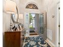 Welcoming entryway with a wood console table, decorative rug, and a view to the home's entry at 4087 Capland Ave, Clermont, FL 34711
