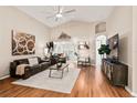 Spacious living room featuring hardwood floors, vaulted ceilings, and stylish contemporary decor at 4087 Capland Ave, Clermont, FL 34711