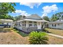 Single-story home with a covered carport and walkway with an awning over the entry and front windows at 506 Richard St, Leesburg, FL 34748