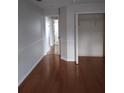 Neutral bedroom with hardwood floors, crisp white trim, and a spacious closet for organized storage at 5075 China Sea Dr, Tavares, FL 32778