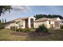 Inviting single-story home with a screened entrance and well-maintained landscaping at 5075 China Sea Dr, Tavares, FL 32778