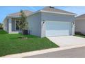Detached two-car garage with ample parking space and a well-maintained lawn at 5129 Blanket Flower St, Apopka, FL 32712