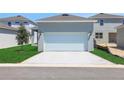 Detached two-car garage with ample parking space and a well-maintained lawn at 5129 Blanket Flower St, Apopka, FL 32712
