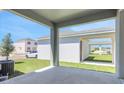 Covered patio overlooking the yard with view of neighboring homes at 5129 Blanket Flower St, Apopka, FL 32712