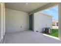 Open patio with concrete floor and access door, perfect for outdoor relaxation at 5129 Blanket Flower St, Apopka, FL 32712