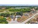 Aerial view of a single-story home with lake views and an expansive lot, as well as mature landscaping at 529 Ed Douglas Rd, Groveland, FL 34736