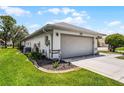 Well-kept home with a two-car garage, lush lawn, and tidy landscaping at 5500 Laver St, Leesburg, FL 34748