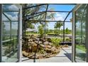 Beautiful lanai showcasing a serene rock water feature and views of the manicured lawn at 5500 Laver St, Leesburg, FL 34748