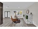Inviting living room features a stone fireplace and ample natural light from the large window at 5526 Parkdale Dr, Orlando, FL 32839