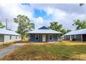 Charming blue single-story home with a metal roof and a cozy front porch at 646 Nw 9Th Ave, Webster, FL 33597