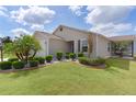 Charming home with well-maintained lawn, manicured landscaping, and beautiful palm trees at 744 Shelton St, The Villages, FL 32163