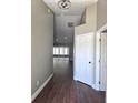 Inviting hallway with wood floors, neutral paint, and recessed lighting leading to the living area at 8025 Cardinal Winds Ln, Mascotte, FL 34753