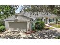 Well-maintained home with a two-car garage and manicured landscaping at 809 Northside Dr, Mount Dora, FL 32757