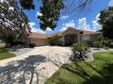 Beautiful single-story home with mature landscaping and a well-maintained lawn at 9010 Laurel Ridge Dr, Mount Dora, FL 32757