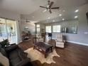 Open concept living room featuring hardwood floors, recessed lighting, and an abundance of natural light at 9010 Laurel Ridge Dr, Mount Dora, FL 32757