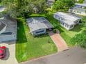 Aerial shot of a well-maintained home with vibrant green lawn and convenient carport at 941 Tarrson Blvd, Lady Lake, FL 32159