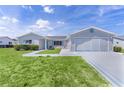 Charming single-story home featuring a well-manicured lawn and an attached two-car garage at 9461 Se 173Rd Ln, Summerfield, FL 34491
