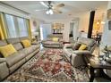 Inviting living room featuring comfortable seating, a stylish rug, and lots of natural light from the windows at 102 Dogwood Trl, Leesburg, FL 34748