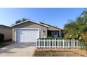 Exterior featuring a two-car garage and front yard at 1070 Pinewood Pl, The Villages, FL 32162