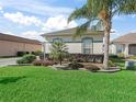 Beautifully landscaped front yard with vibrant green grass and manicured shrubs at 11820 Se 178Th St, Summerfield, FL 34491