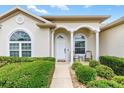 Charming front entrance with arched windows and pillars, plus a cozy seating area at 11884 Se 179Th St, Summerfield, FL 34491
