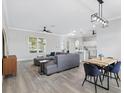 Open-concept living room with a modern ceiling fan and stylish furnishings at 11884 Se 179Th St, Summerfield, FL 34491