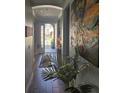 Welcoming home entryway featuring tile floors, a decorative plant, and an artful butterfly painting on the wall at 1231 Merion Dr, Mount Dora, FL 32757