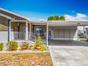 Attractive single-story home showcasing a covered carport and well-maintained landscaping at 1236 Elkhart Cir, Tavares, FL 32778