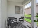 Covered patio featuring stylish outdoor seating and a decorative rug, perfect for relaxation at 17471 Se 110Th Ter, Summerfield, FL 34491