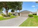 Charming home featuring manicured landscaping, a spacious driveway, and a two-car garage at 2015 Palo Alto Ave, The Villages, FL 32159