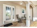 Cozy front porch featuring a decorative glass door, seating, and neutral-toned finishes at 2015 Palo Alto Ave, The Villages, FL 32159