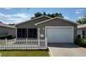 Charming single-story home featuring a well-manicured lawn and attached two-car garage at 2039 Thurmond Ave, The Villages, FL 32162