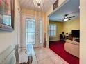 Inviting foyer with decorative glass door and a glimpse into the living room at 2131 Burley Ave, Clermont, FL 34711
