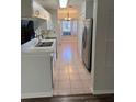 Bright kitchen with white cabinets and stainless steel appliances and tile floors at 2381 Missouri Ave, St Cloud, FL 34769