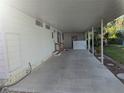 A spacious, covered carport with a tiled floor, offering ample parking and protection from the elements at 2871 Myakka River Rd, Tavares, FL 32778
