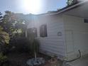 This cozy home features a landscaped yard and a well-maintained exterior with an outdoor storage area at 2871 Myakka River Rd, Tavares, FL 32778