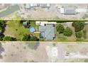 An aerial view of the home, pool, yard, outbuilding, and long driveway at 28924 Discovery Rd, Tavares, FL 32778