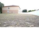 Large, empty backyard surrounded by a white fence at 3329 White Blossom Ln, Clermont, FL 34711