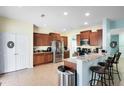 Bright kitchen features stainless steel appliances, granite counters, and a breakfast bar with seating at 356 Giovani Blvd, Clermont, FL 34715